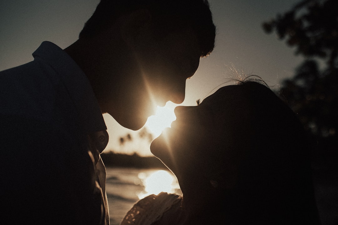 silhouette of couple kissing during sunset