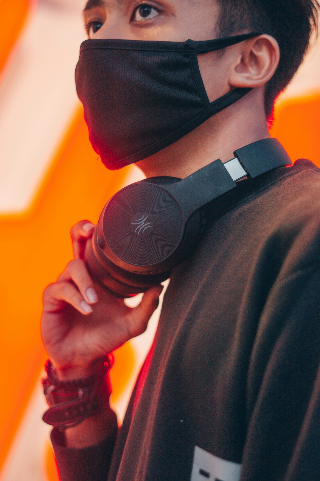person holding black sony headphones