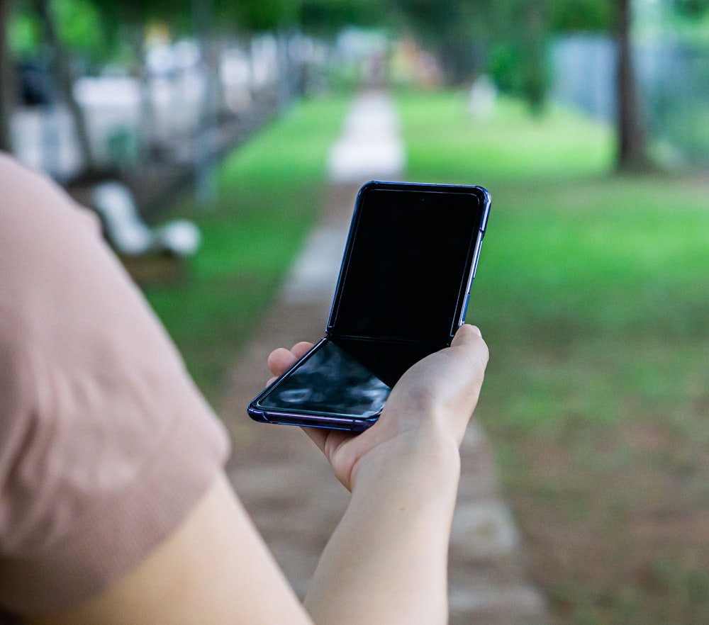 person holding black android smartphone