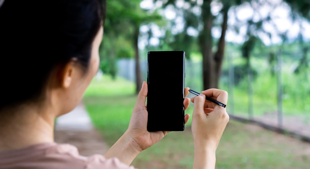 person holding black android smartphone