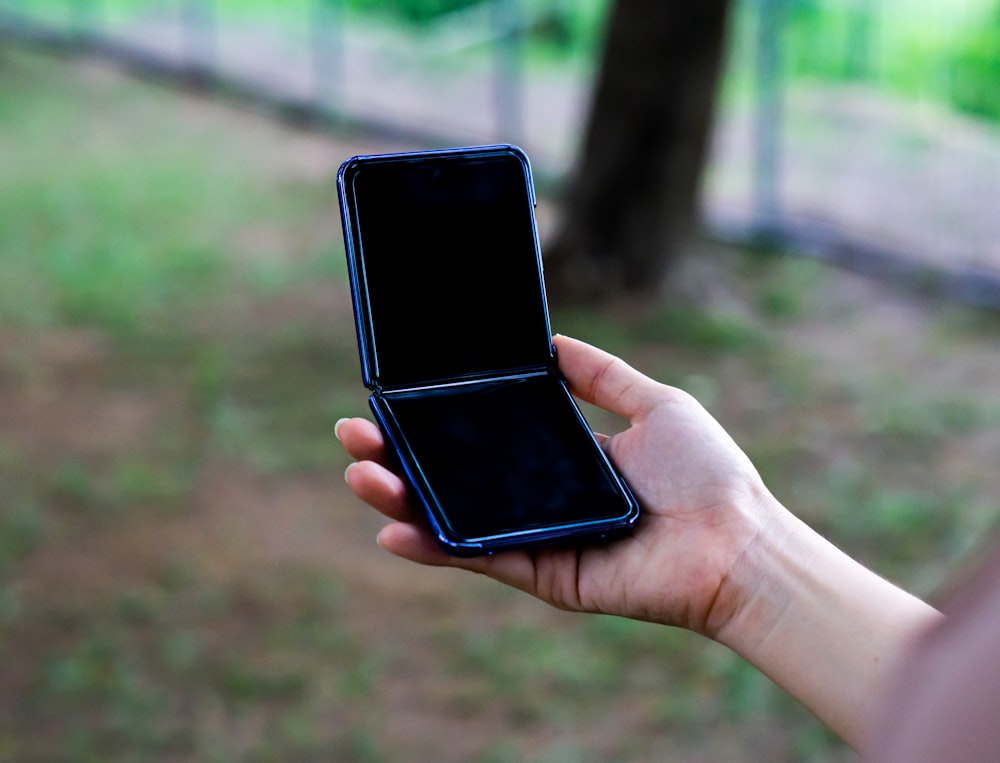 person holding black android smartphone