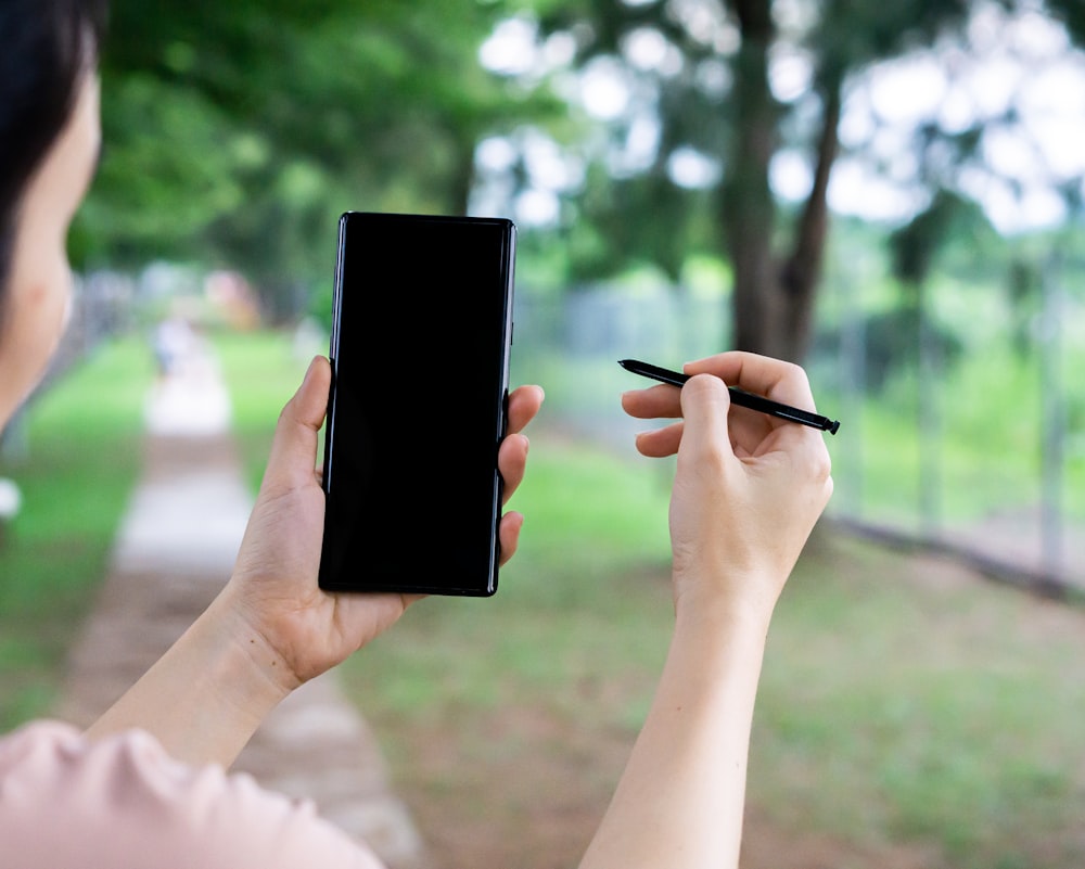 person holding black tablet computer