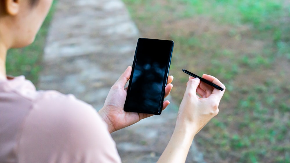 person holding black android smartphone