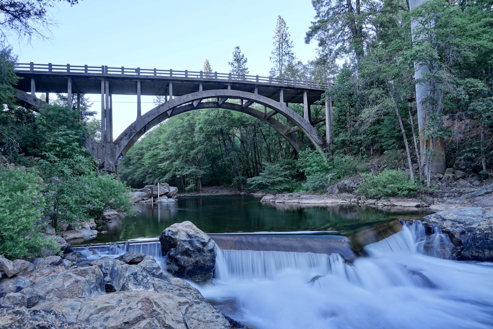 bridge over river under white sky during daytime