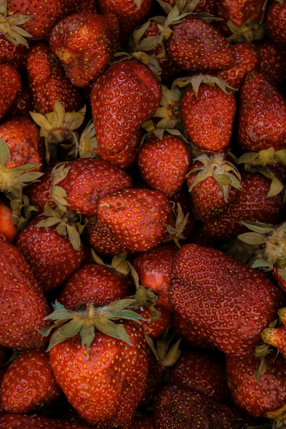 red strawberries on green leaves