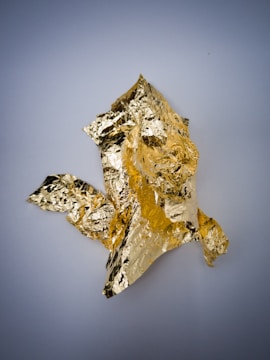 An artistic shot of a gold foil print in natural light.