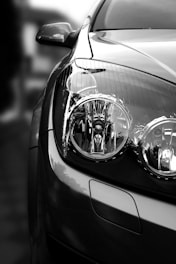 grayscale photo of car headlight