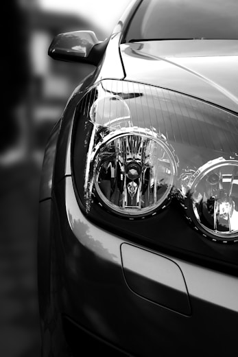 grayscale photo of car headlight