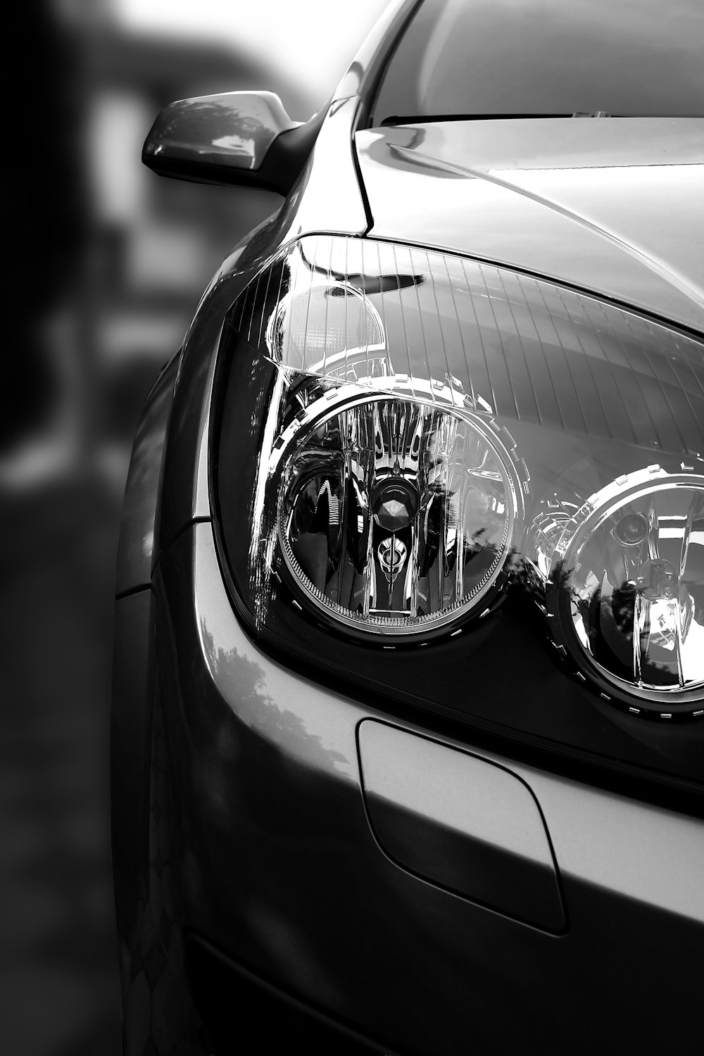 grayscale photo of car headlight