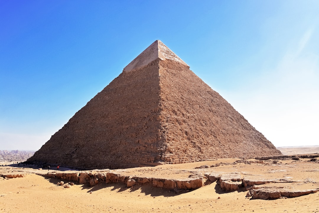 pyramid on brown sand under blue sky during daytime