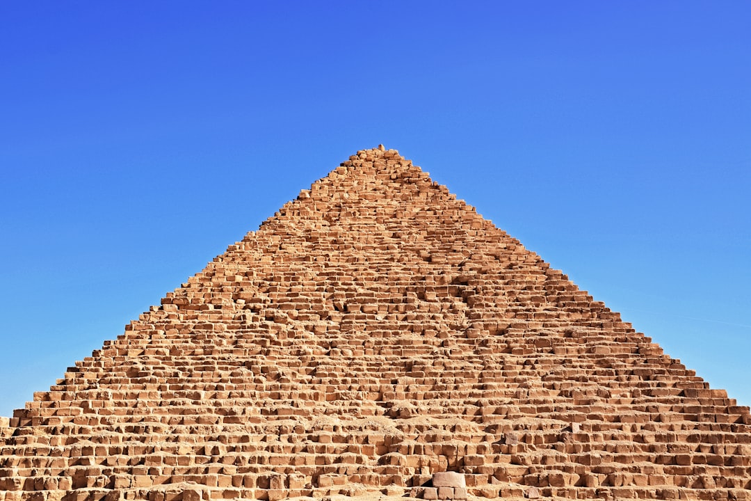 brown brick wall under blue sky during daytime