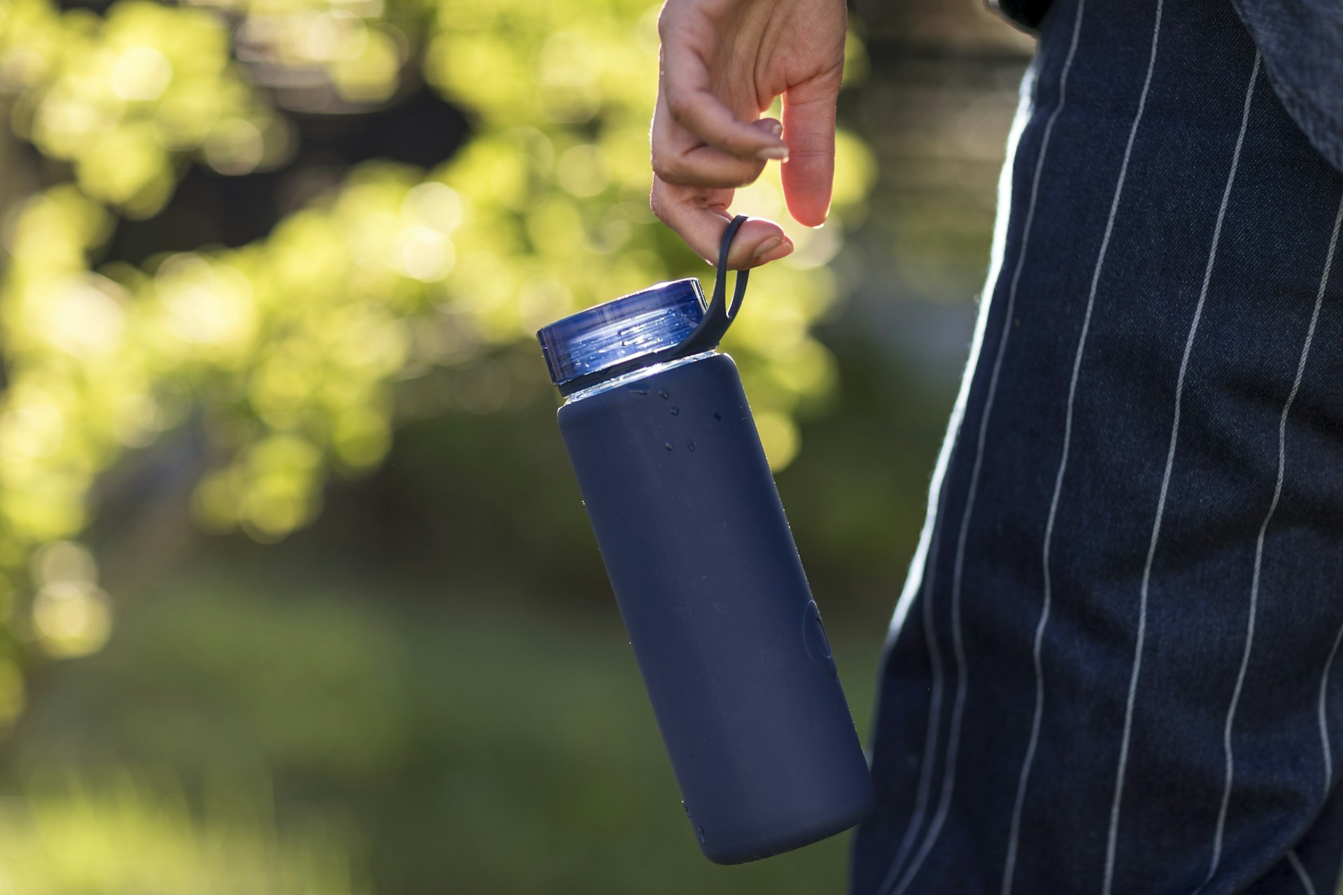 person holding blue plastic cup