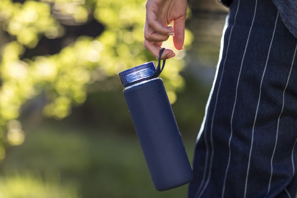 person holding blue plastic cup