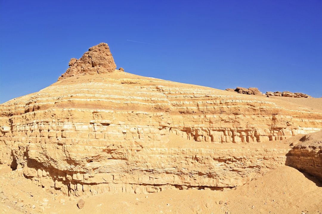 brown rock formation under blue sky during daytime