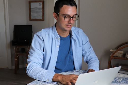 man in white dress shirt wearing black framed eyeglasses