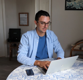 man in white dress shirt wearing black framed eyeglasses