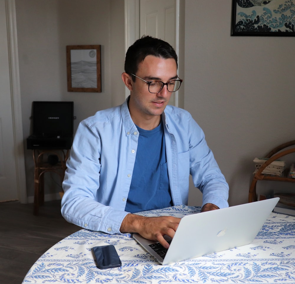 man in white dress shirt wearing black framed eyeglasses