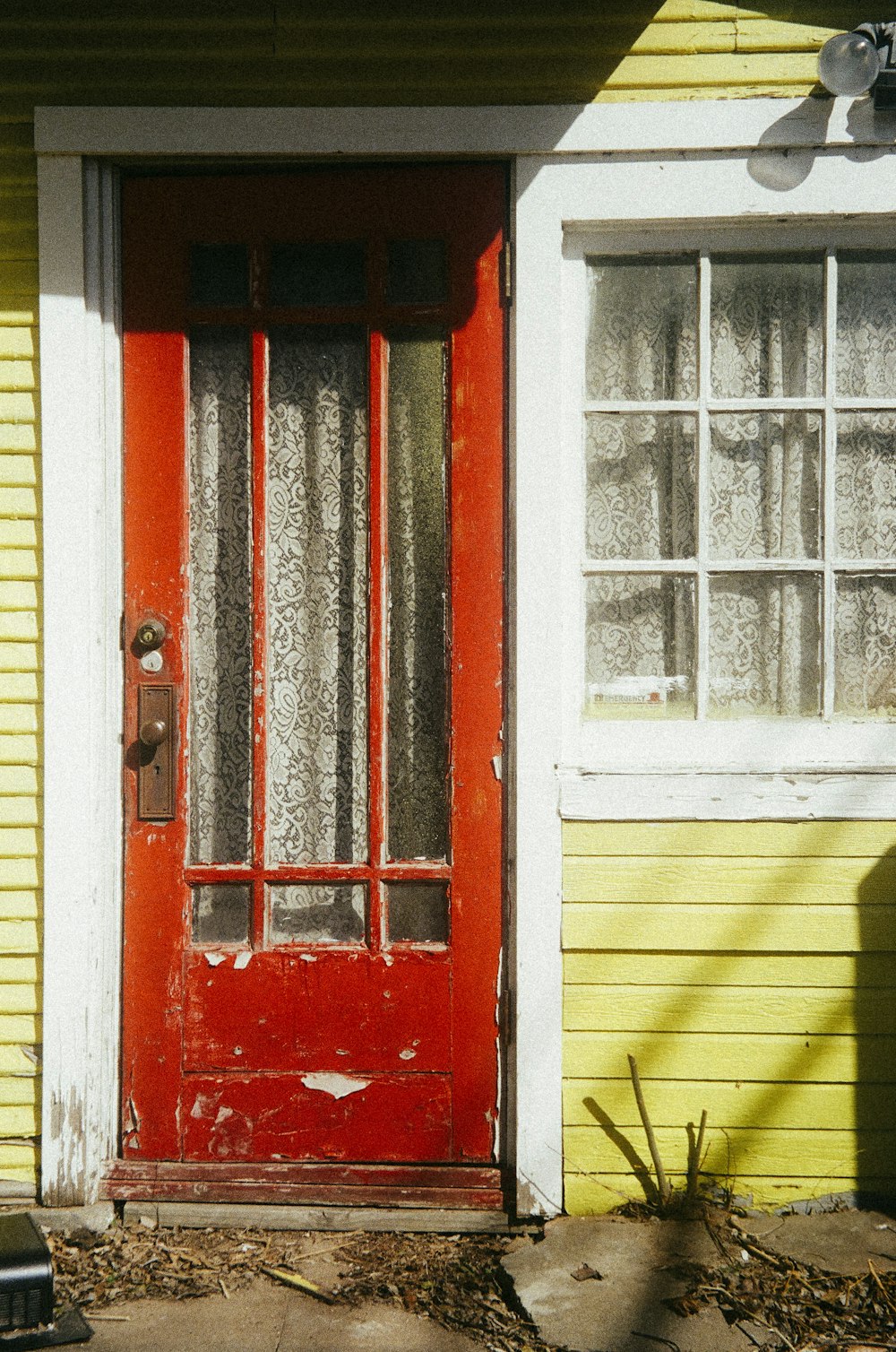 red wooden door with white wooden frame