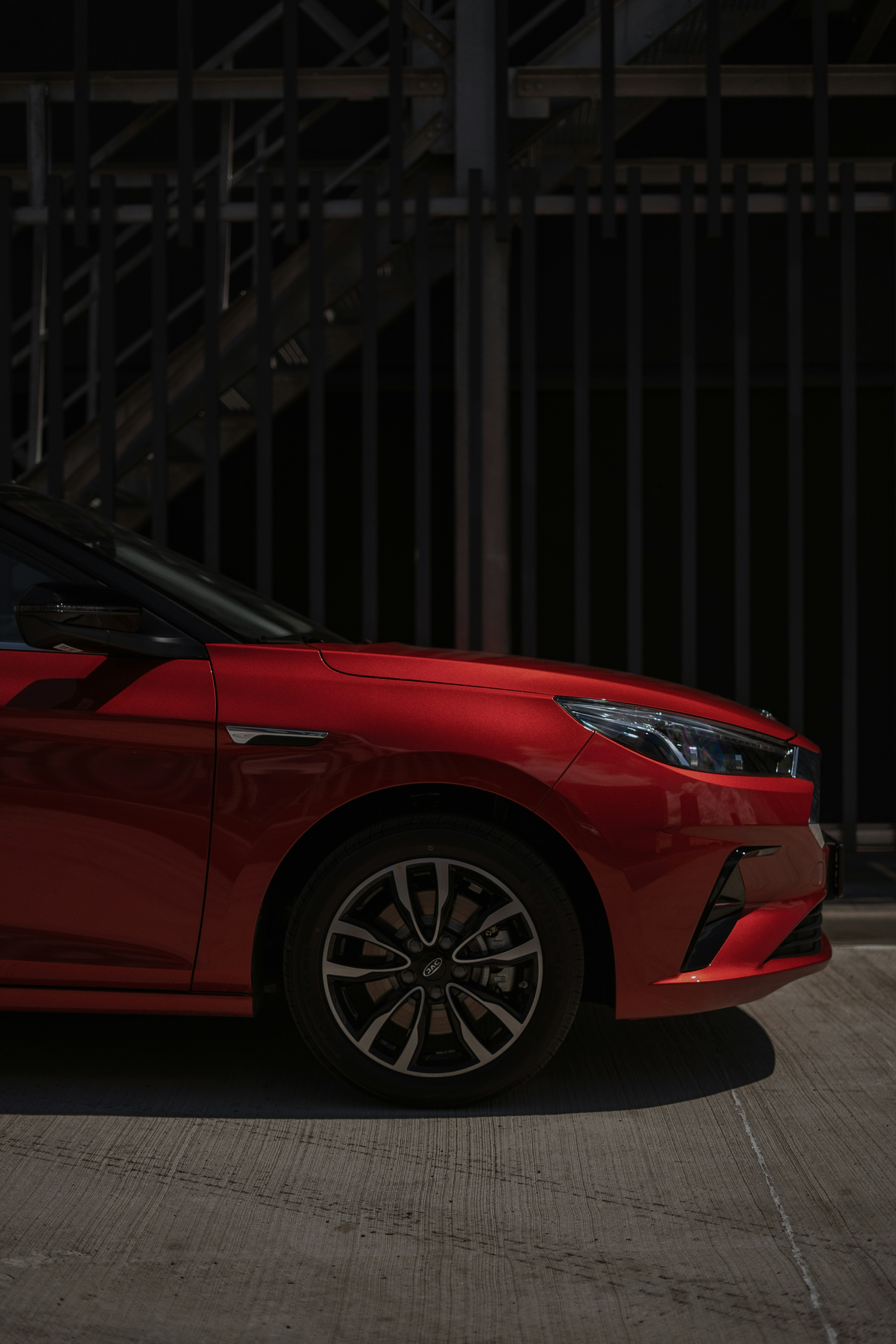 red car parked near building