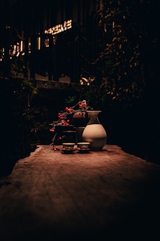 A rustic wooden table set with various traditional meads and ales surrounded by natural scenery.