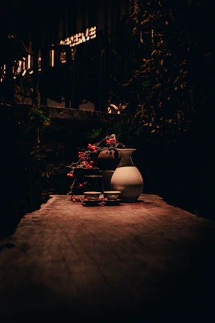 Close-up of a rustic wooden table set with candles and wildflowers, inviting intimacy.