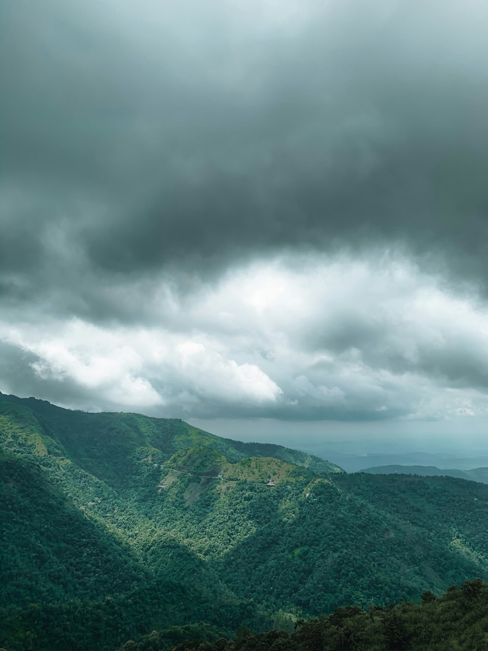 green mountains under white clouds during daytime