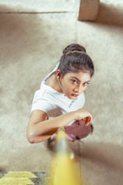 girl in white t-shirt and white pants sitting on floor