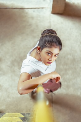 girl in white t-shirt and white pants sitting on floor