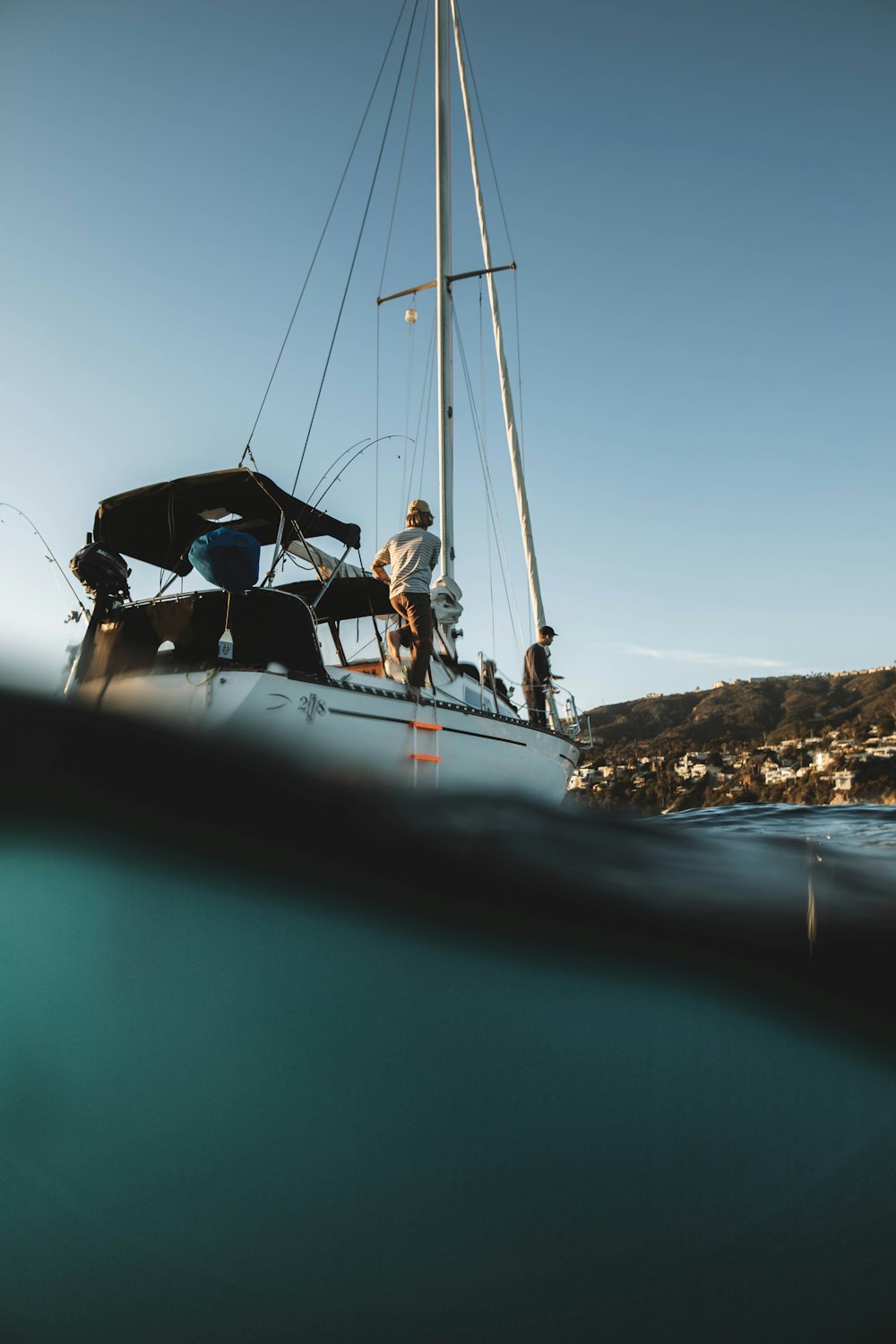 white and black boat on sea during daytime