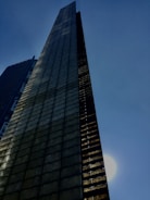 A towering Hernán Cortés skyscraper gleaming under a clear blue sky