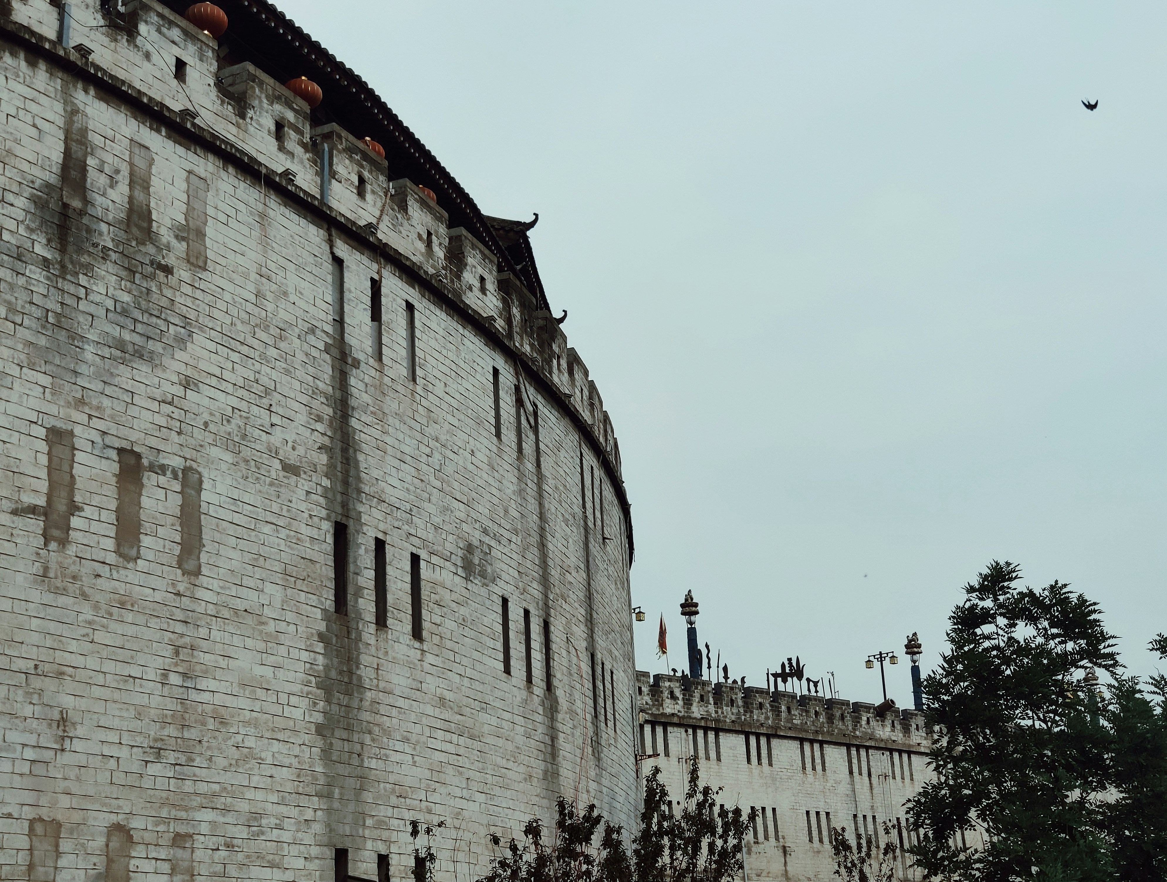gray concrete building near green trees during daytime