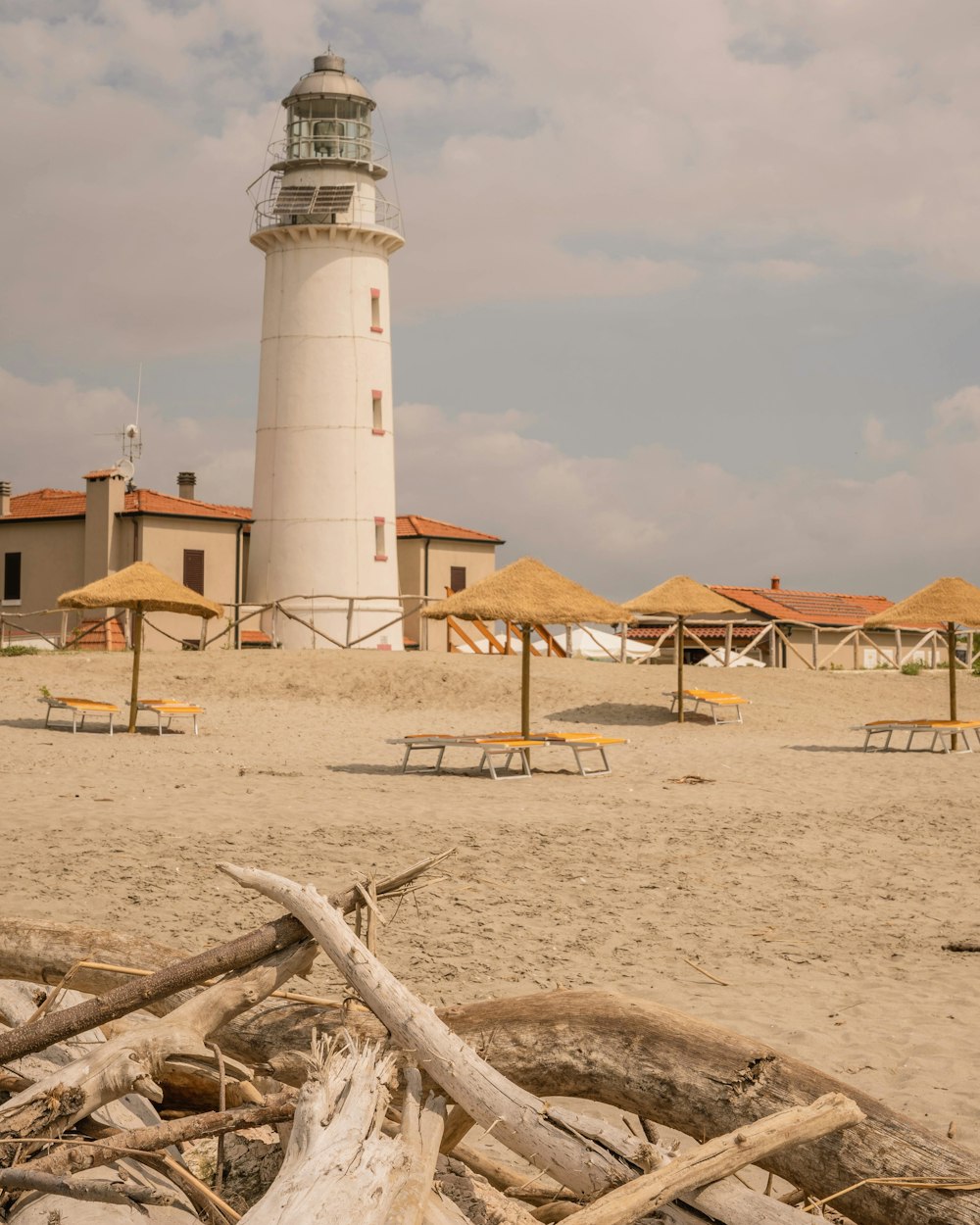white and brown lighthouse on brown sand during daytime