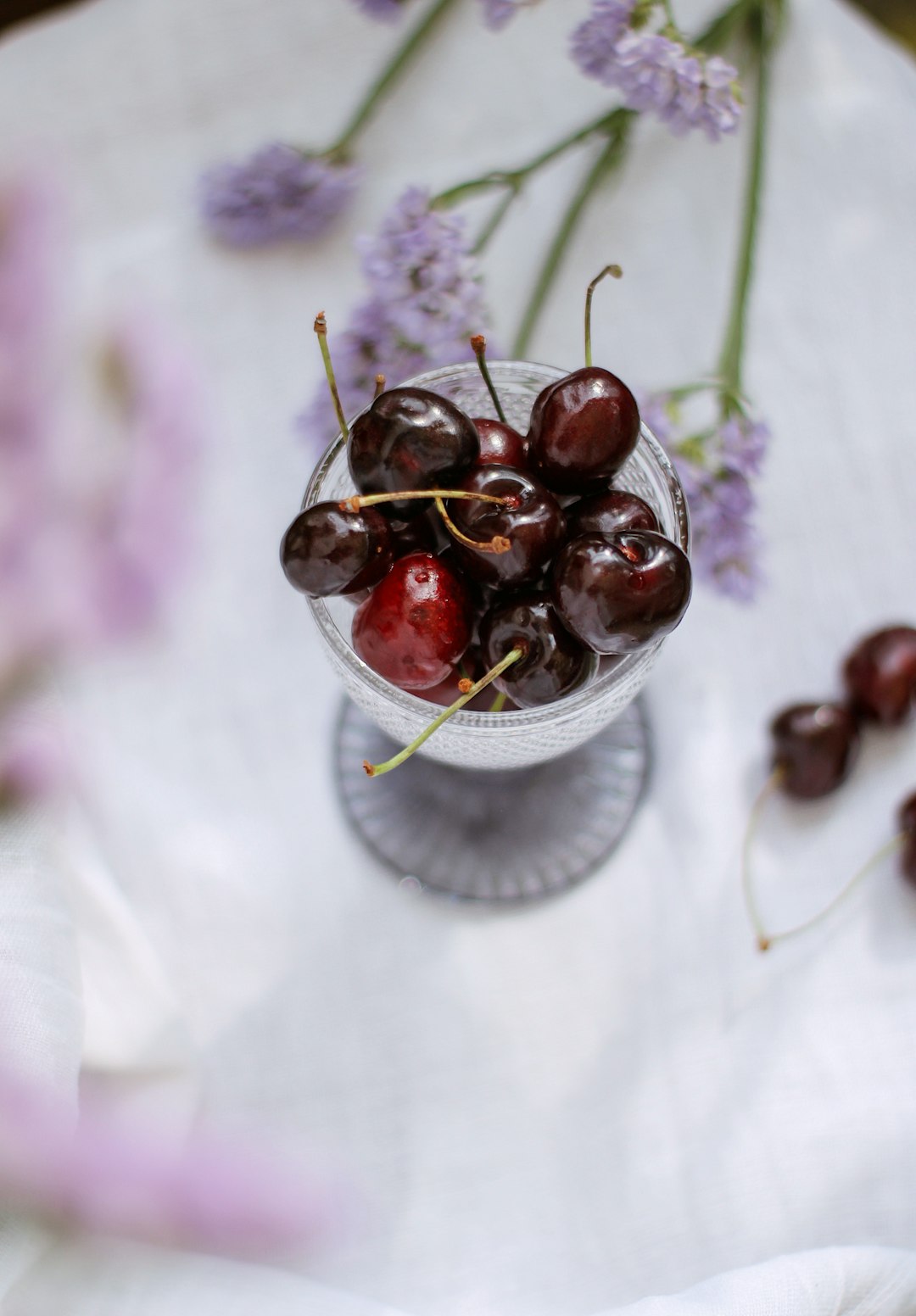 red round fruit on clear glass bowl