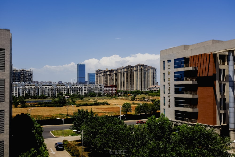 white and blue concrete building near green trees during daytime