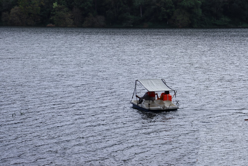 white and red boat on body of water during daytime