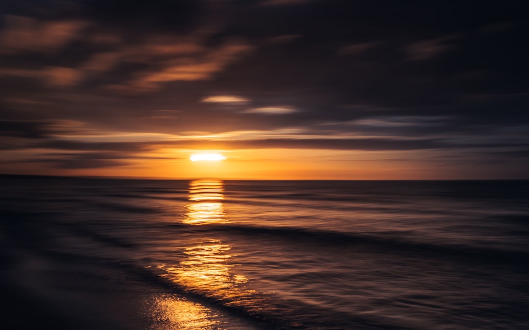 body of water during sunset