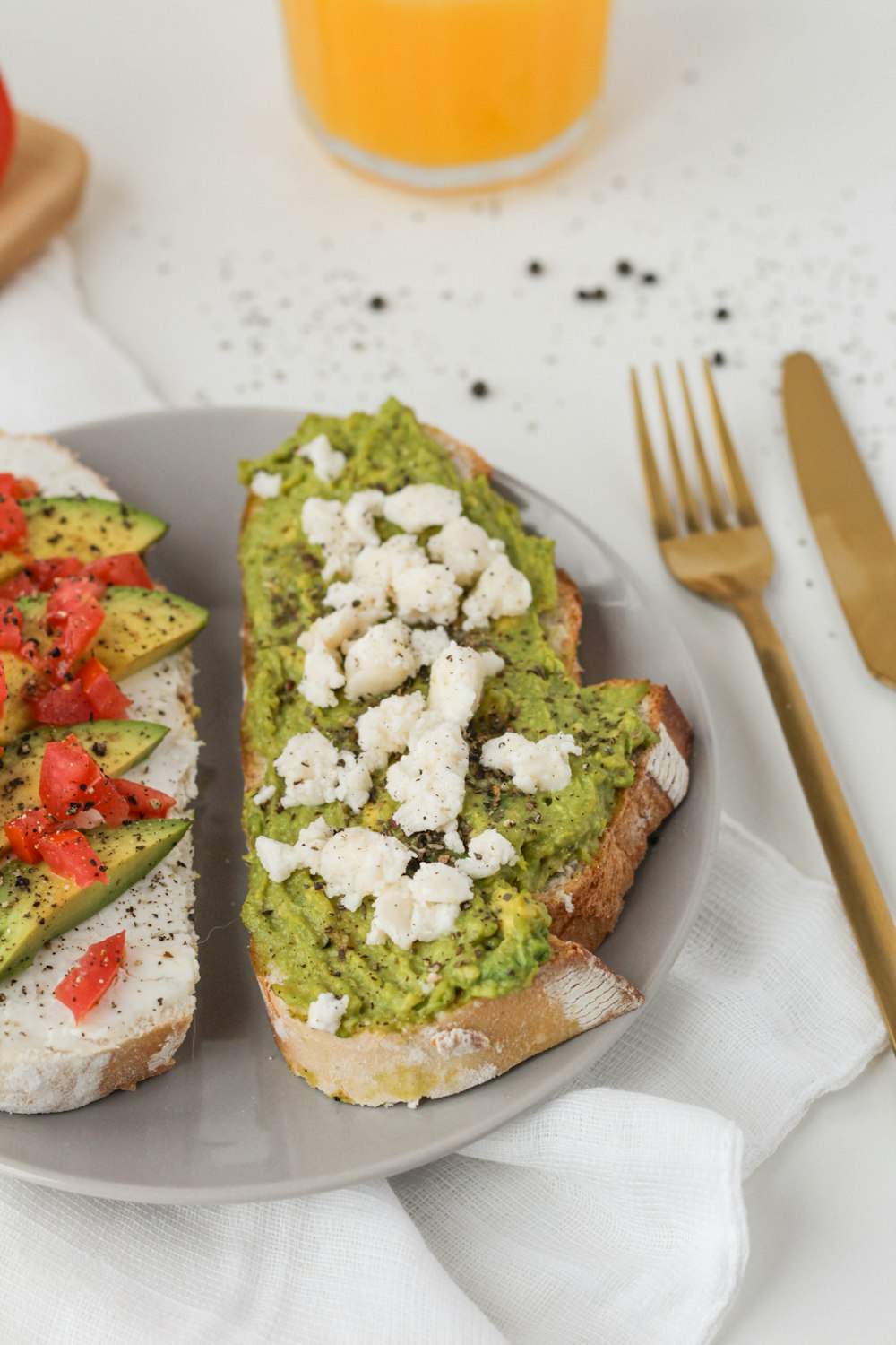 bread with green vegetable and white cream on white ceramic plate