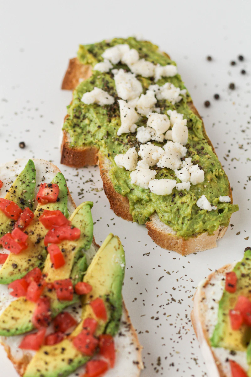 Smashed avocado on toast with feta and tomato