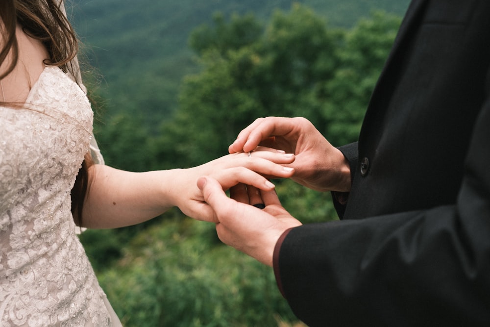 woman in black blazer holding her hand