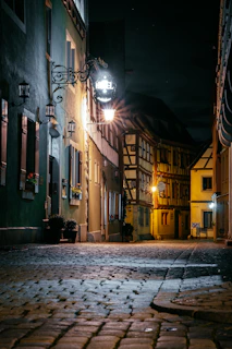 Cozy boutique hotel room featuring rustic decor and a view of cobblestone streets.
