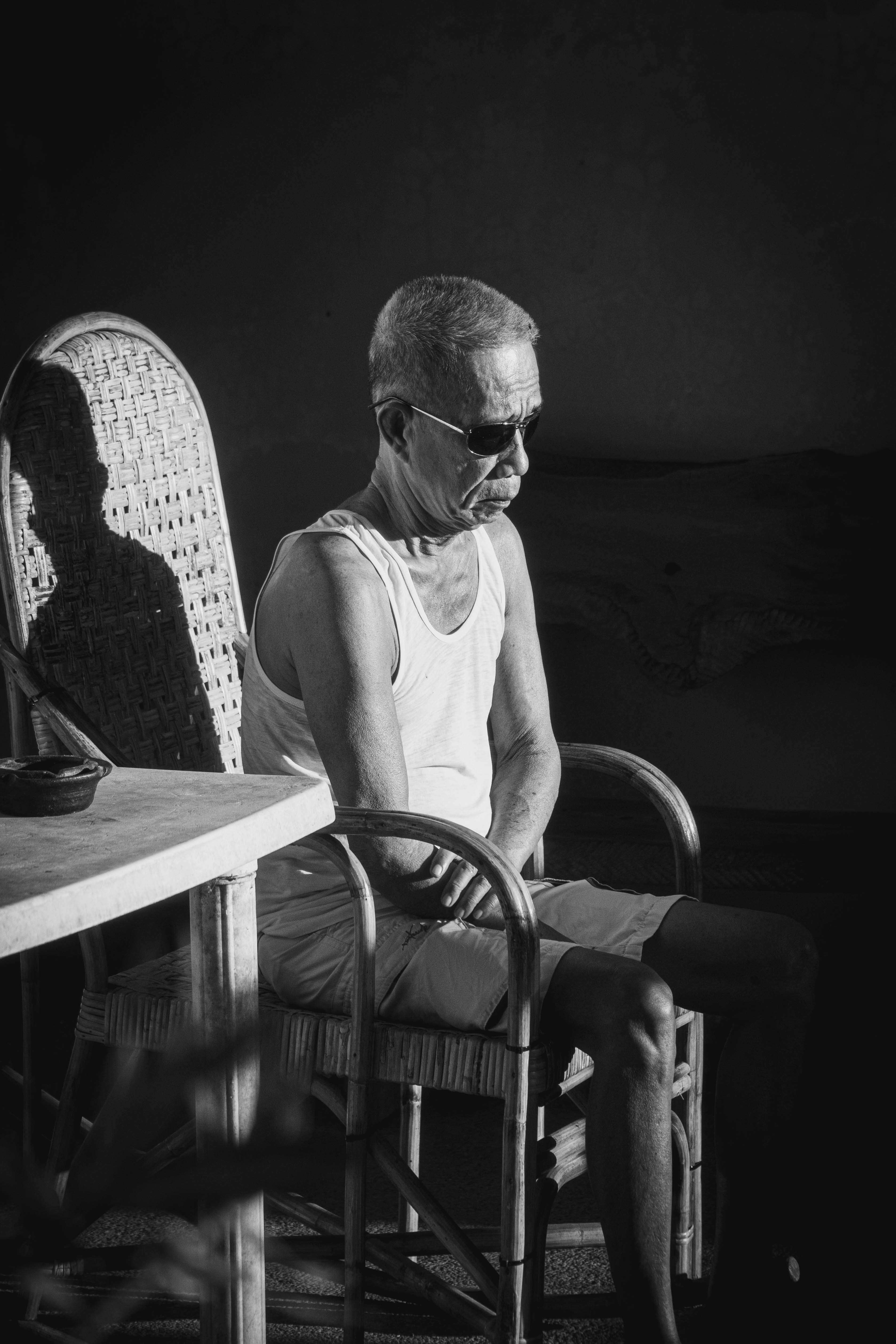 a man sitting in a chair next to a table