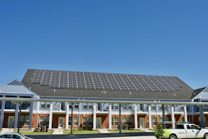 A robust solar inverter installed on a wall, converting sunlight into electricity for a busy commercial building.