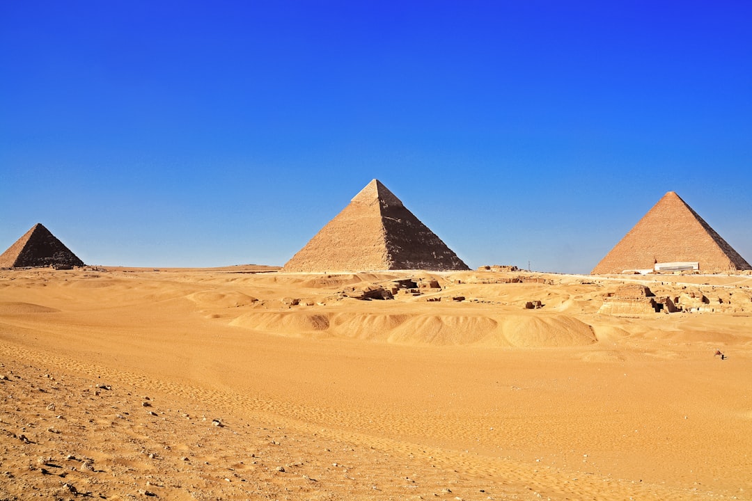 pyramid on desert under blue sky during daytime