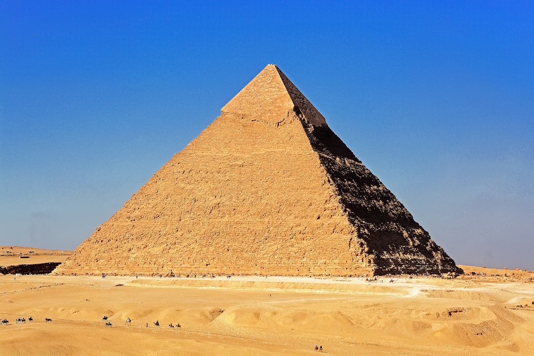 pyramid on desert under blue sky during daytime