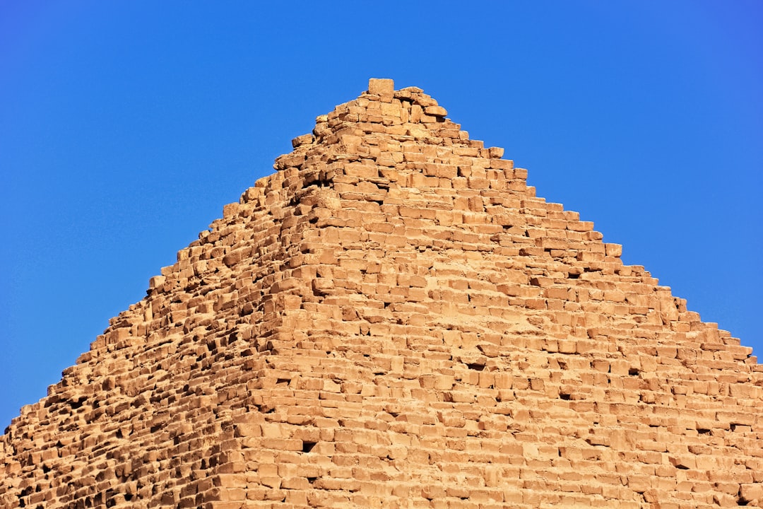 brown brick wall under blue sky during daytime