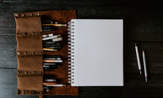 white spiral notebook on brown wooden table