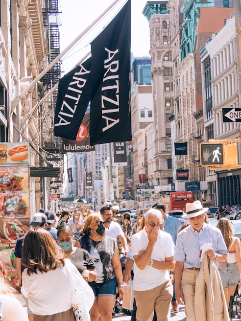 A lively street scene in downtown Toronto with colorful murals and bustling pedestrians.
