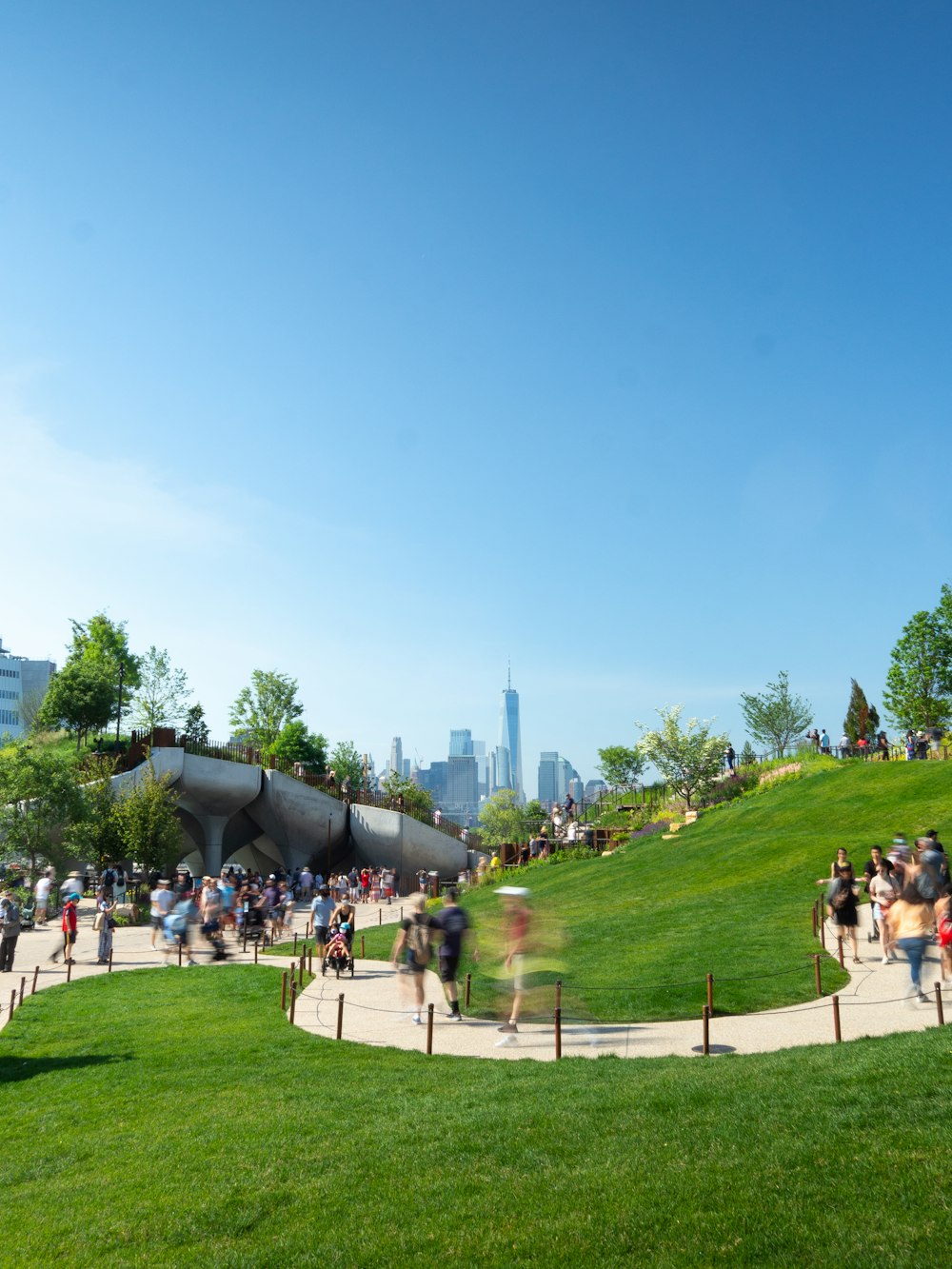 people sitting on white bench on green grass field during daytime