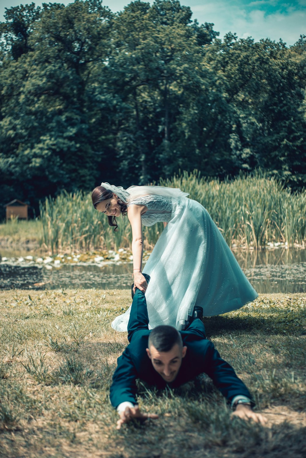 man and woman kissing on green grass field during daytime