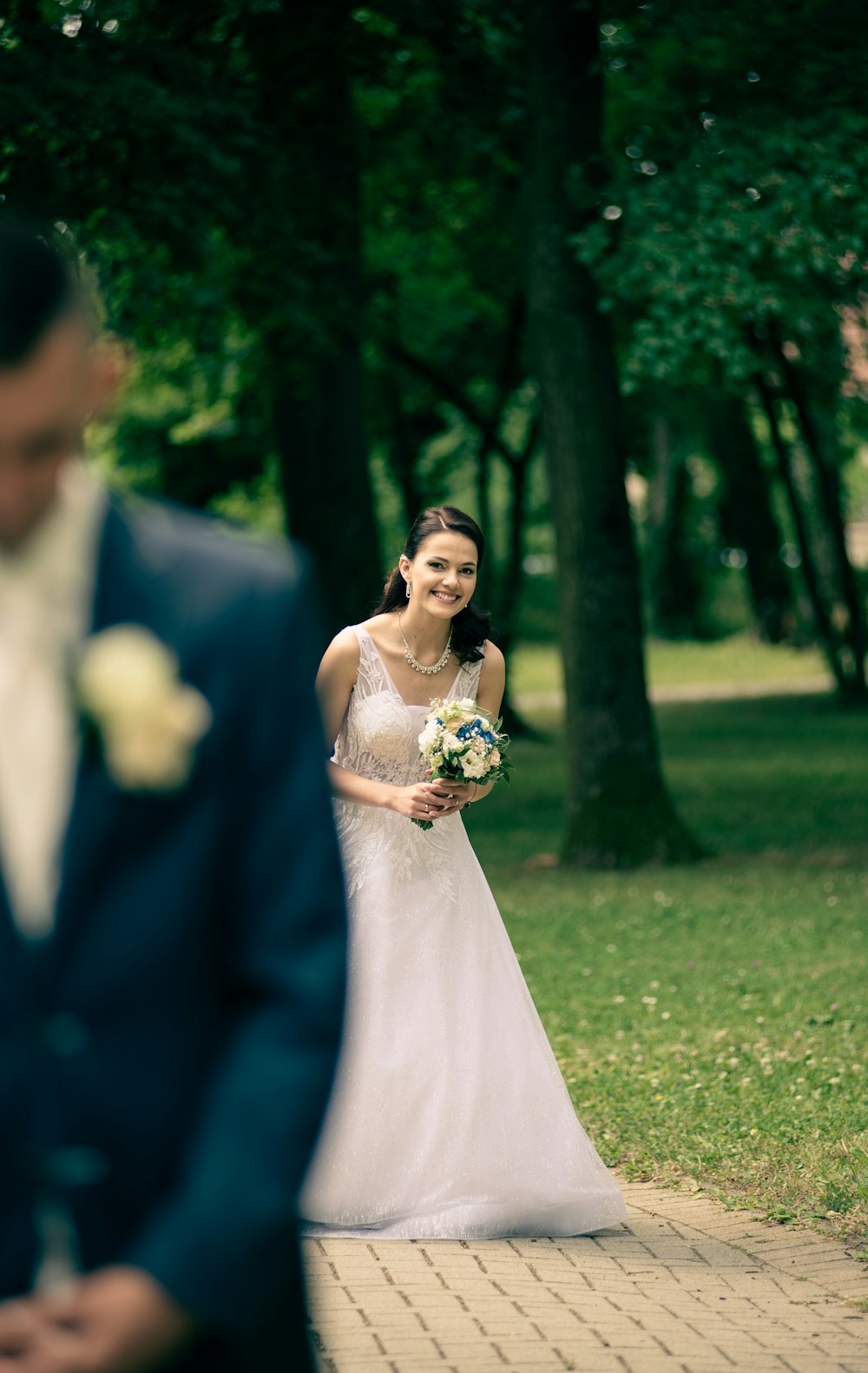 woman in white wedding gown holding bouquet of flowers